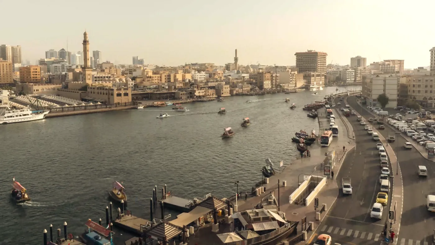 Dubai Creek with abras on the water and the old town on the bank